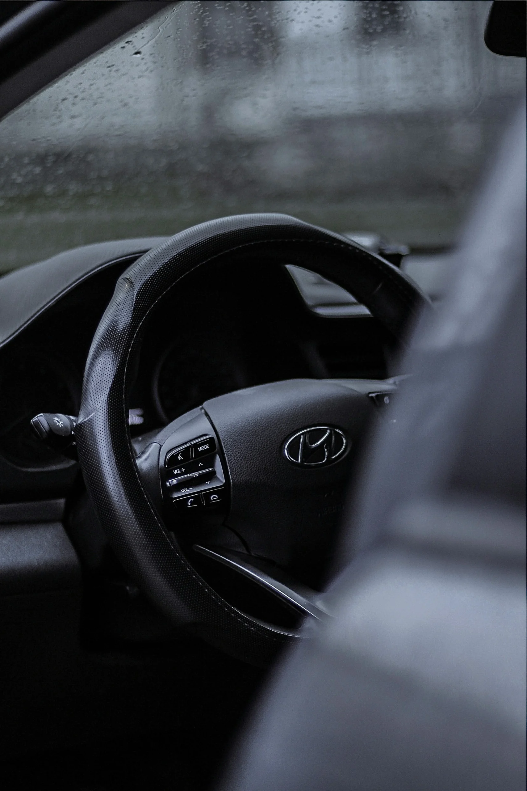 Hyundai vehicle interior showing steering wheel and control buttons