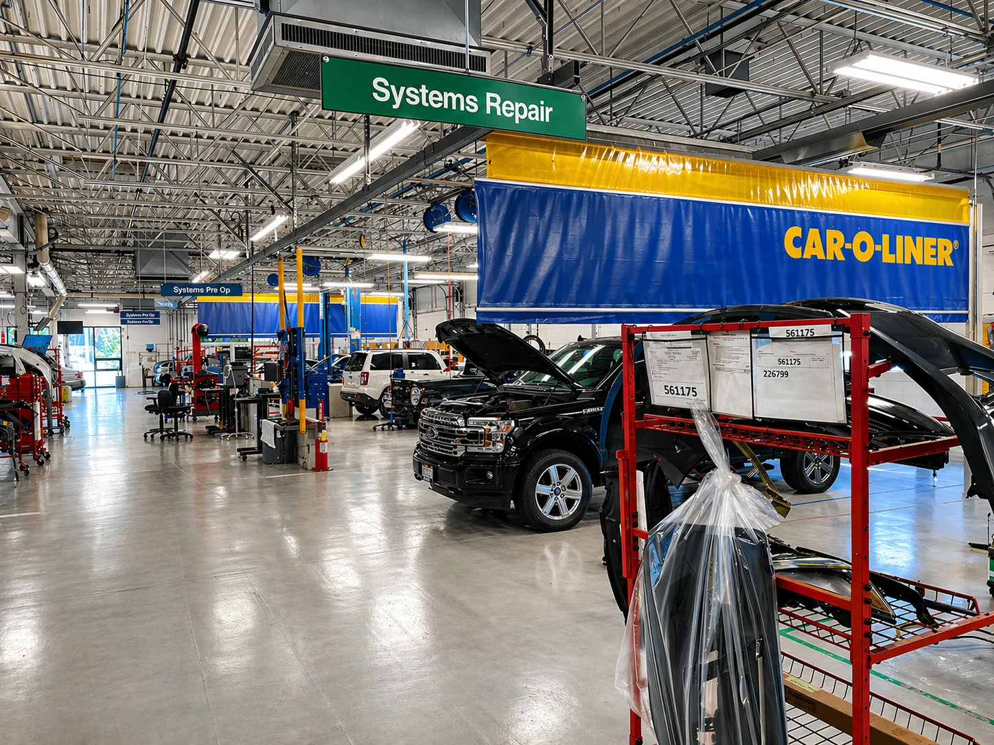 Collision repair production floor with systems repair area and Car-O-Liner structural workstations